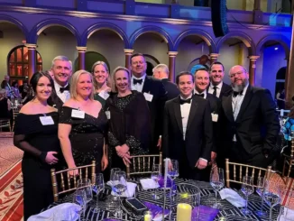 Amy Gowder, president and CEO of Defense & Systems (fifth from left), with members of the XA100 team at the 2025 Laureate Awards ceremony.